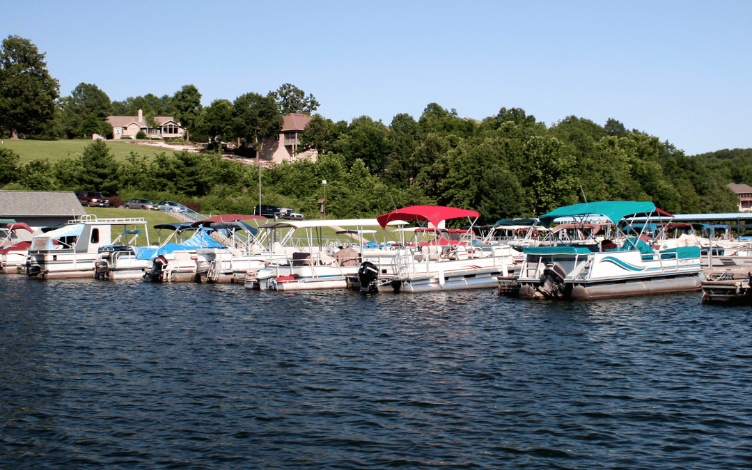 Image of several boats in line tied up to a dock.